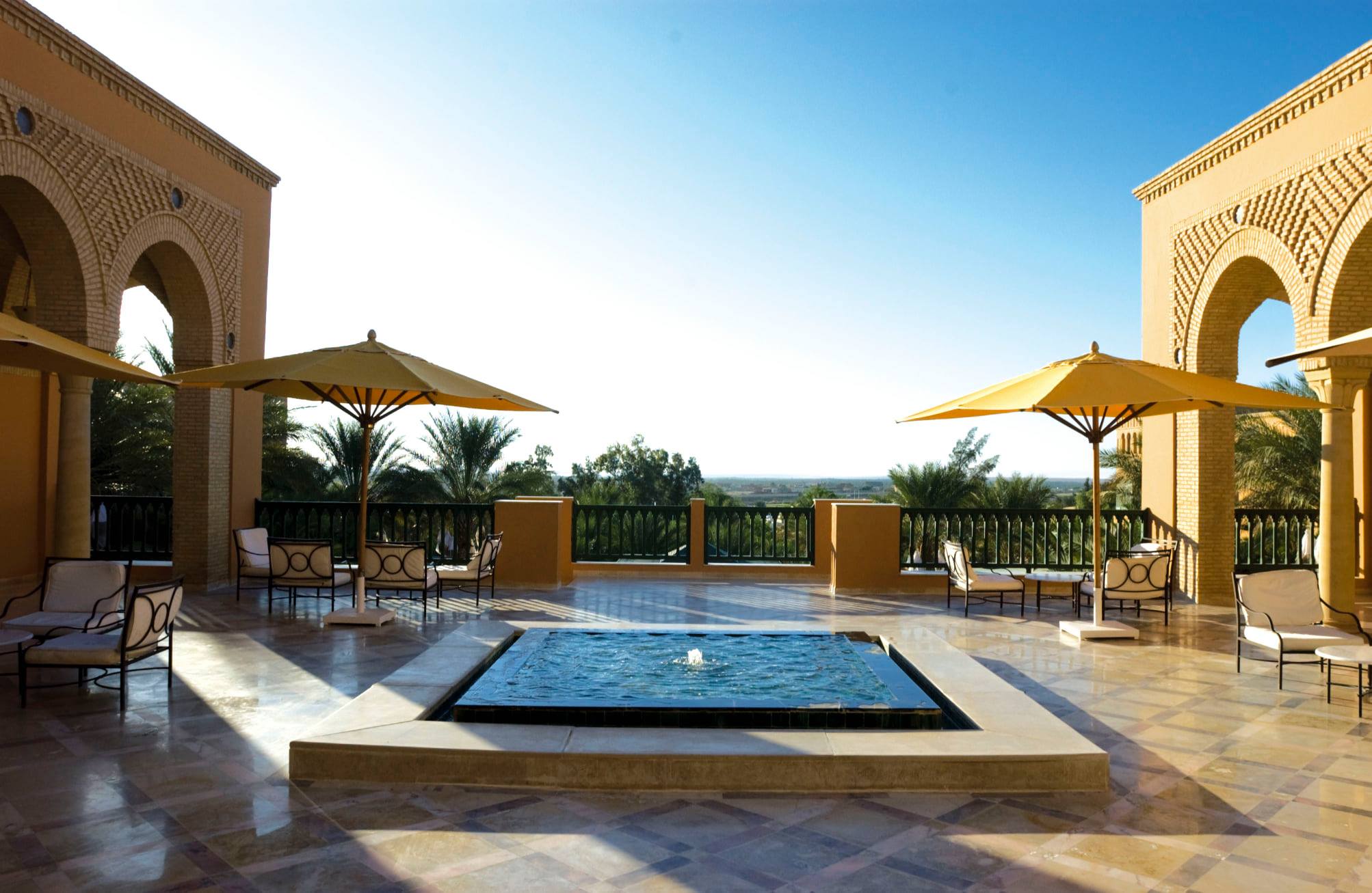Oasis pool and palm canopy at dusk